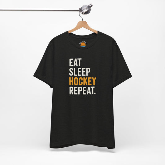 Black heather t-shirt with 'Eat Sleep Hockey Repeat' text on a hanger against a white background