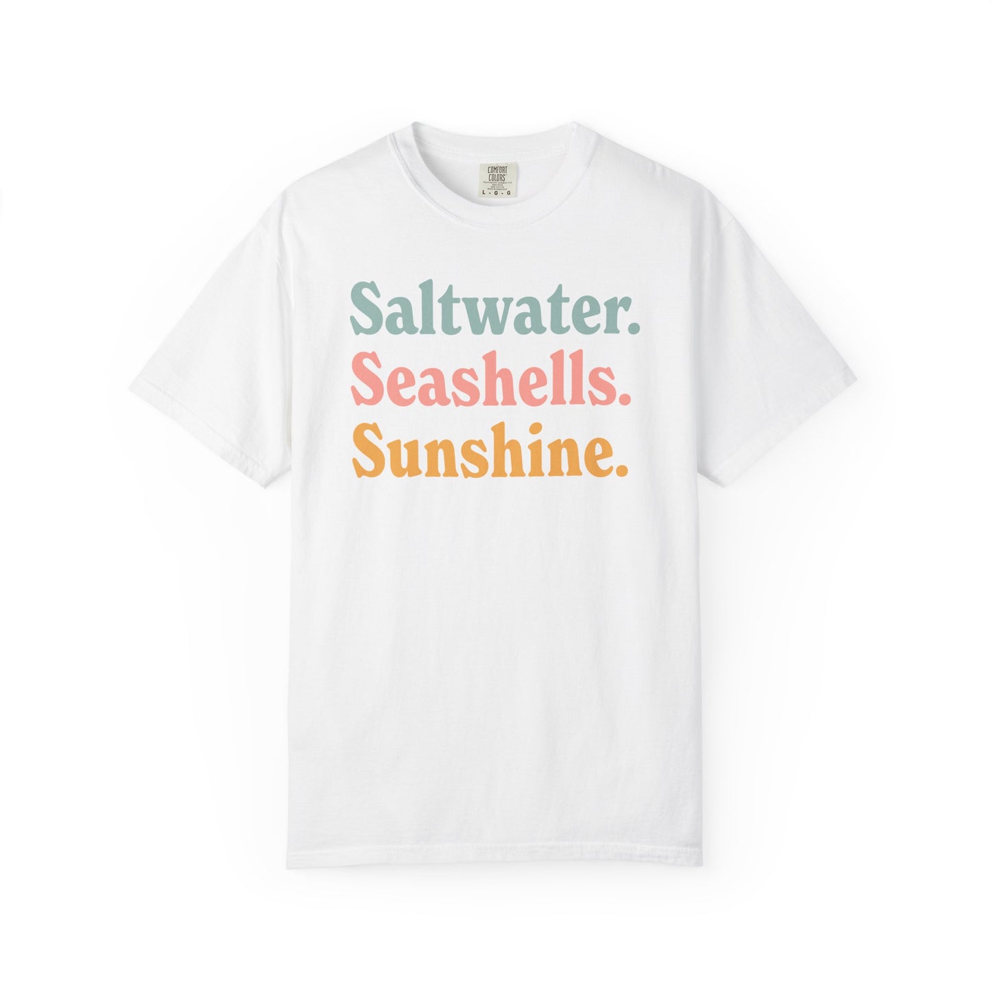 White Comfort Colors t-shirt with colorful text 'Saltwater. Seashells. Sunshine.' on a white background