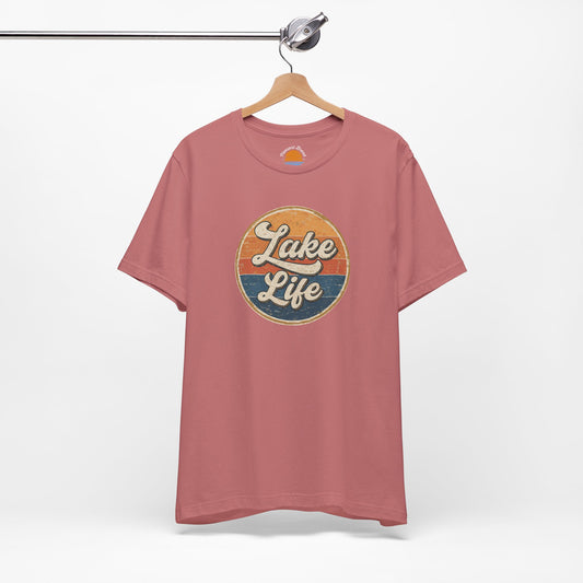 Mauve t-shirt with 'Lake Life' graphic on a hanger against a white background