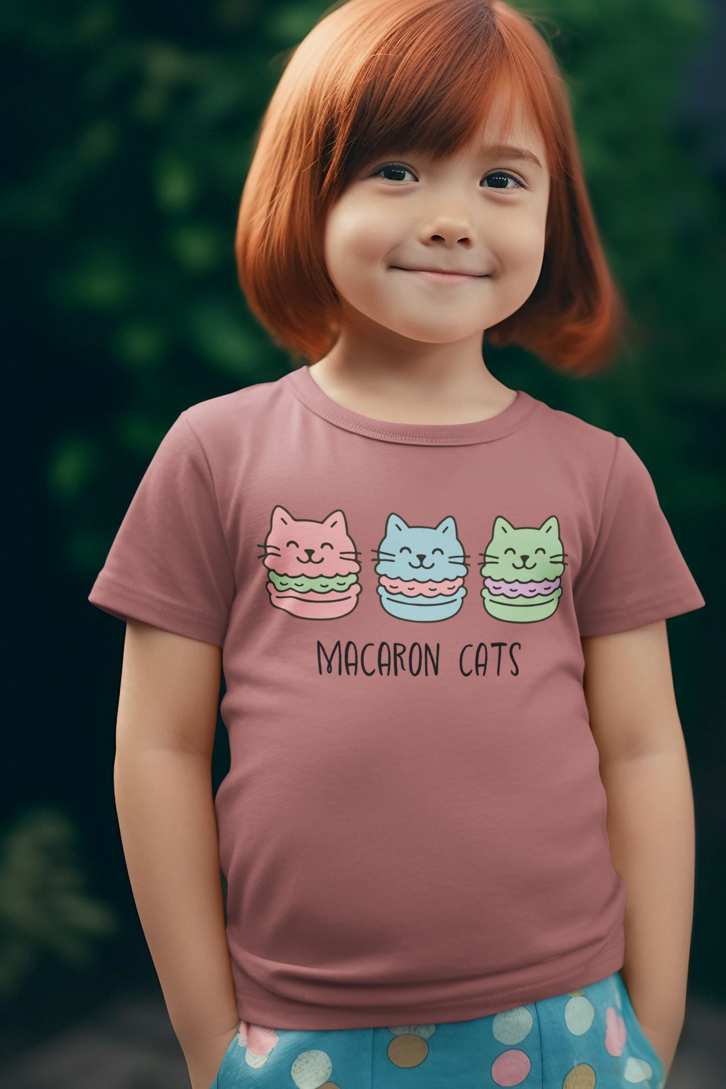 Adorable child with bob haircut wearing heather mauve Macaron Cats Toddler T-Shirt with sweet smile
