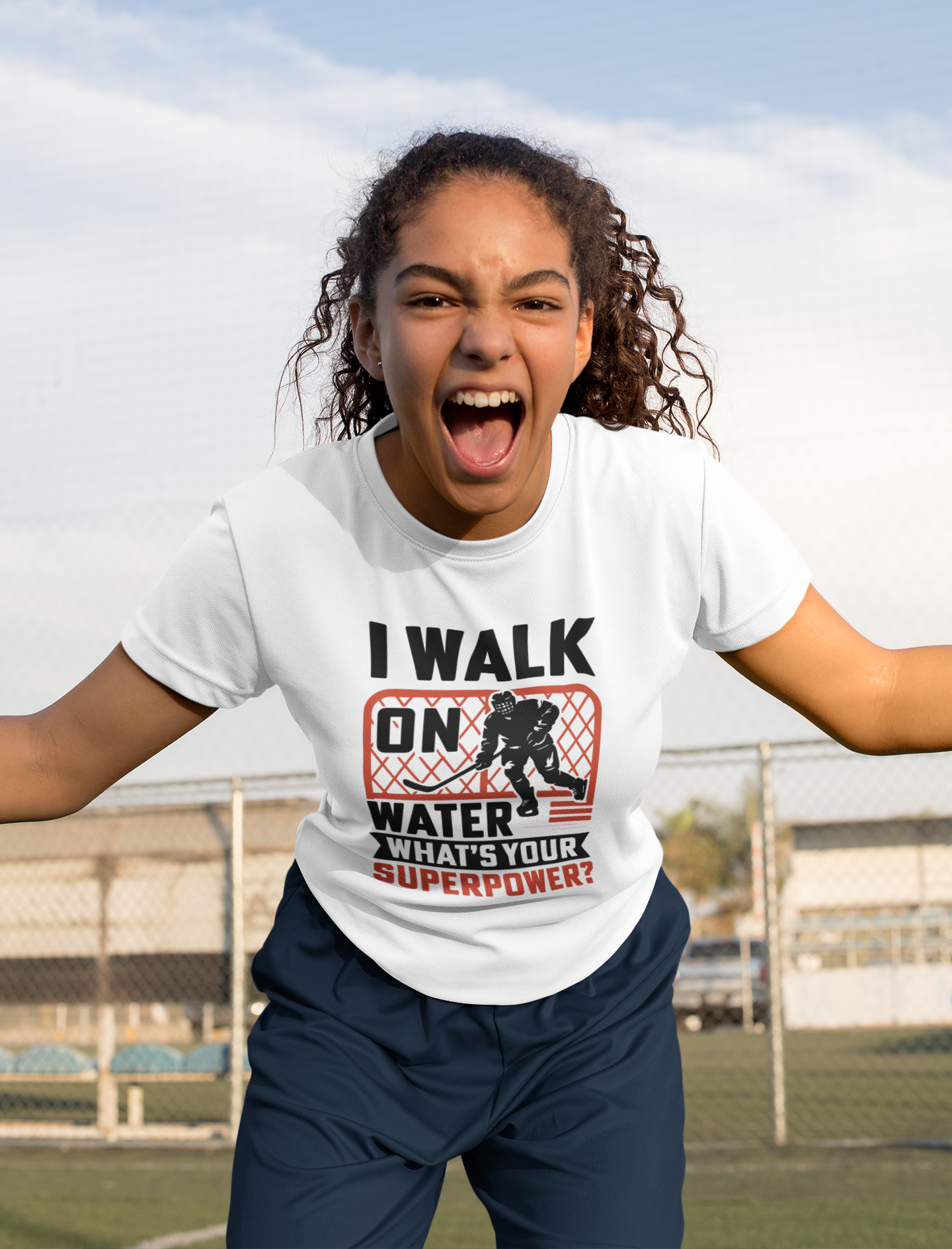 Enthusiastic young athlete showcasing Walk On Water Youth T-Shirt with mouth open in excitement