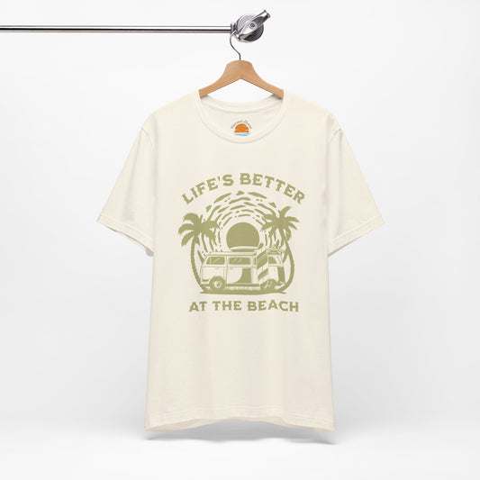 Beige t-shirt with 'Life's Better at the Beach' graphic on a hanger against a white background
