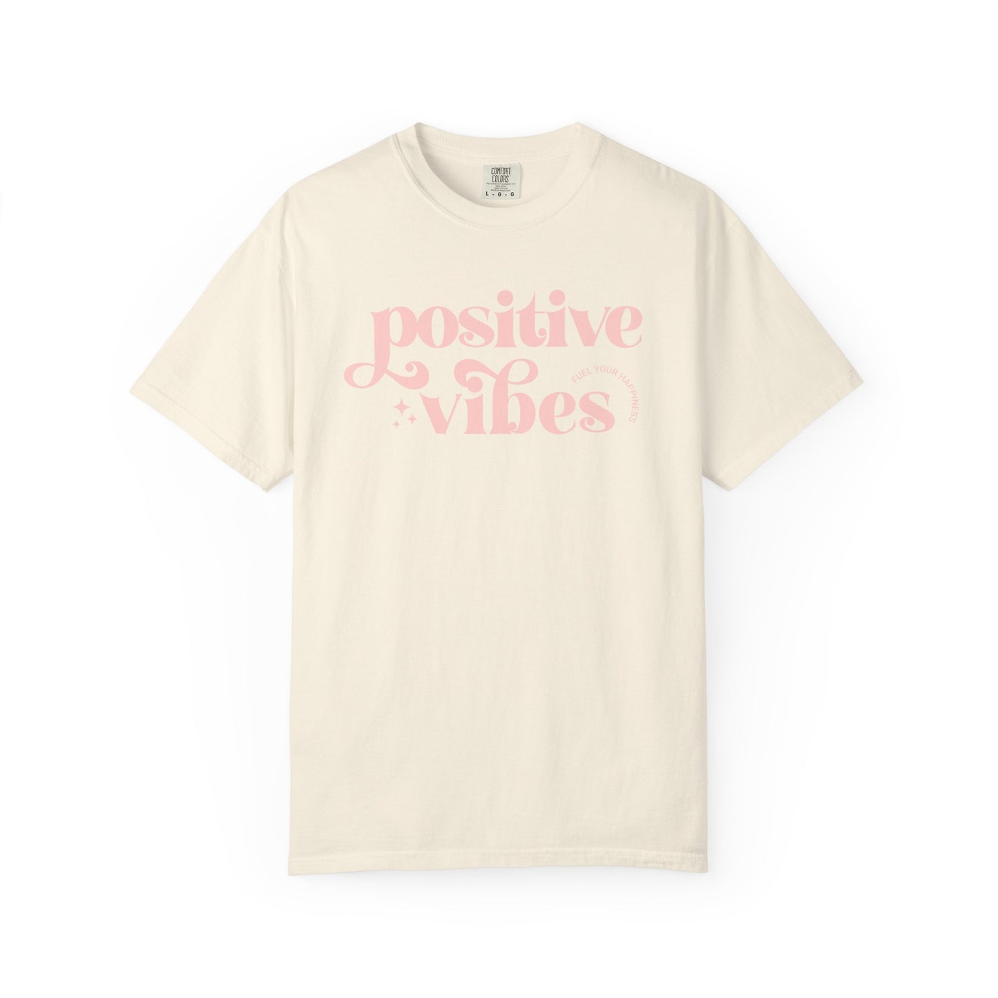 Beige t-shirt with pink 'Positive Vibes' text on a white background