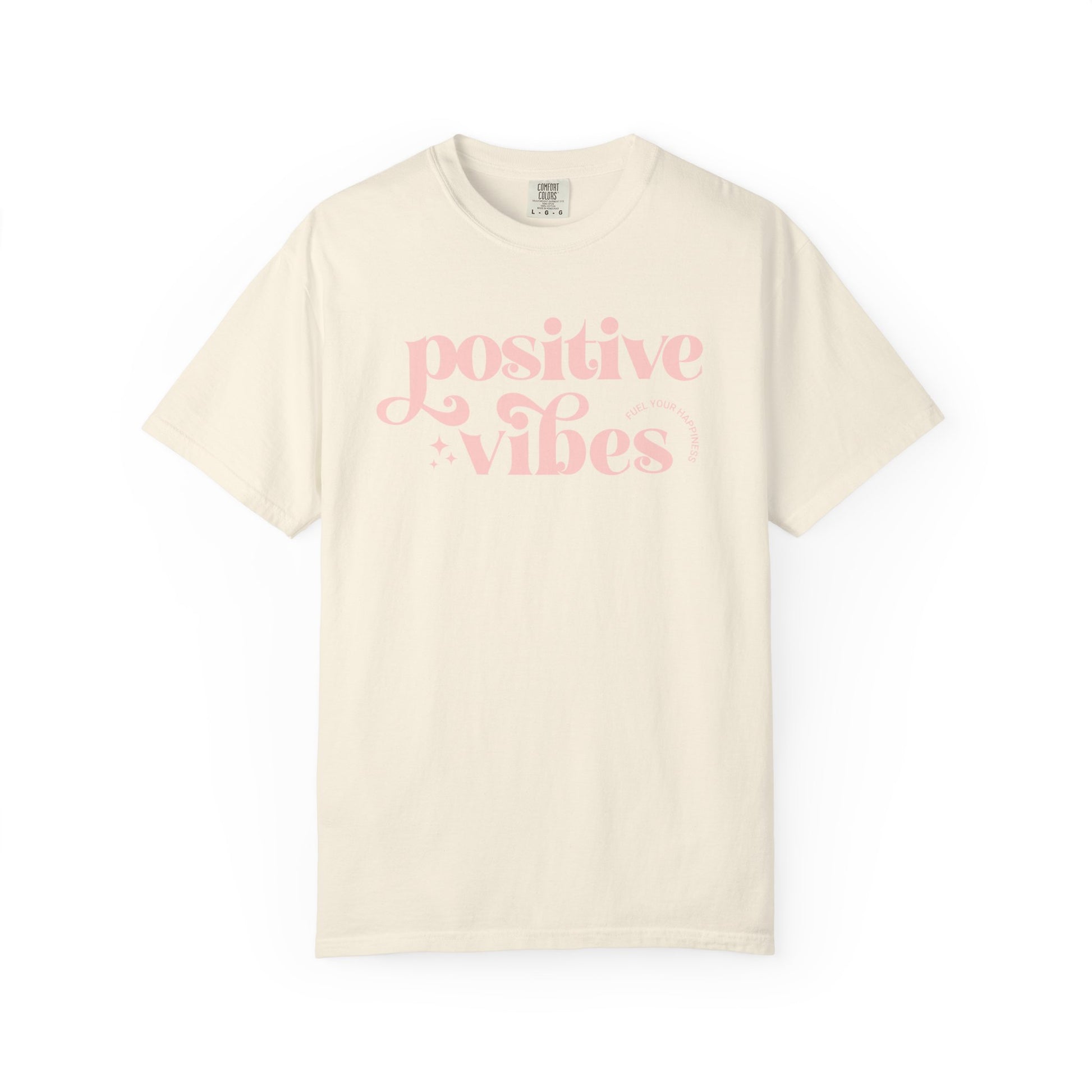 Beige t-shirt with pink 'Positive Vibes' text on a white background