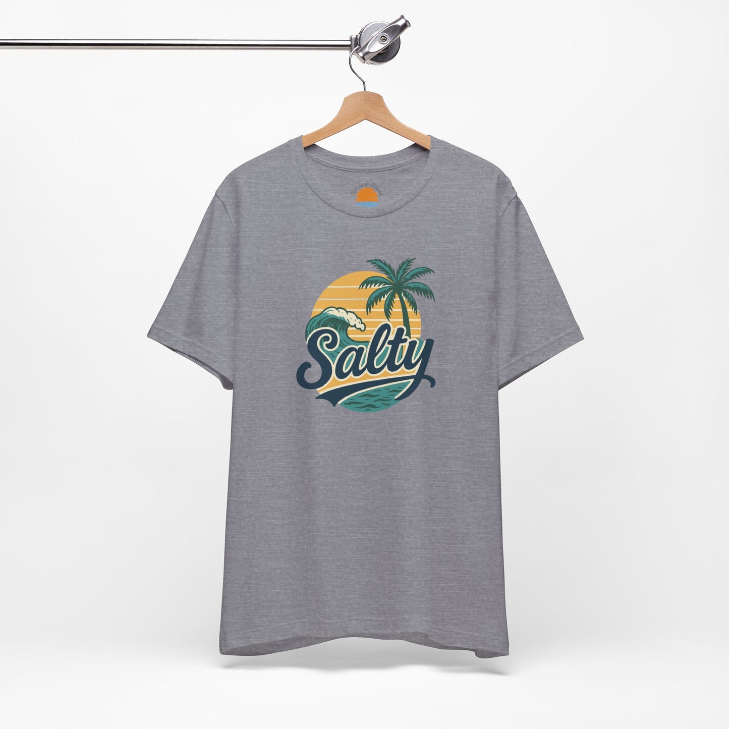 Gray t-shirt with 'Salty' graphic design featuring palm trees and a sunset on a hanger against a white background.