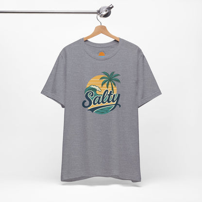 Gray t-shirt with 'Salty' graphic design featuring palm trees and a sunset on a hanger against a white background.
