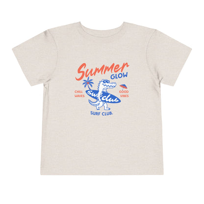 Beige t-shirt with 'Summer Glow Surf Club' graphic design on a white background