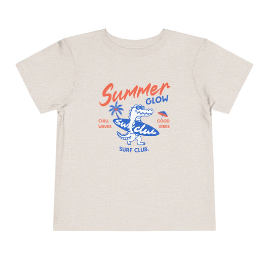 Beige t-shirt with 'Summer Glow Surf Club' graphic design on a white background