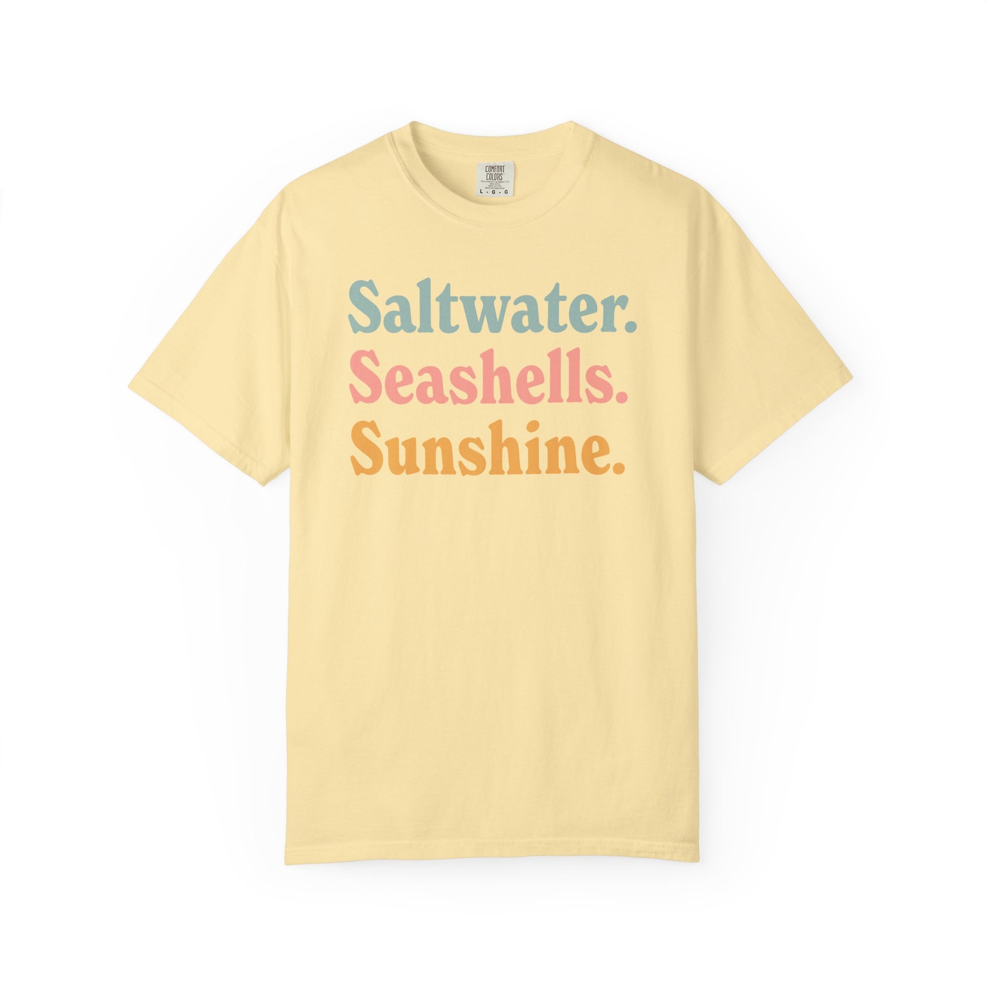 Banana Comfort Colors t-shirt with colorful text 'Saltwater. Seashells. Sunshine.' on a white background