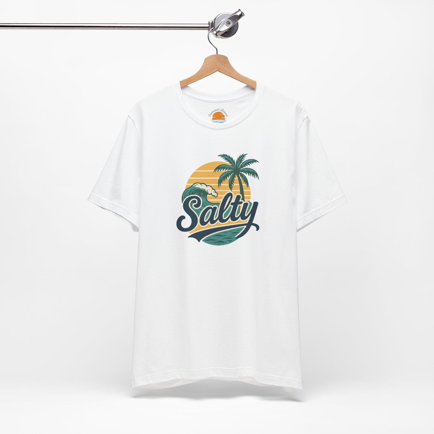 White t-shirt with 'Salty' graphic design featuring palm trees and a sunset on a hanger against a white background.