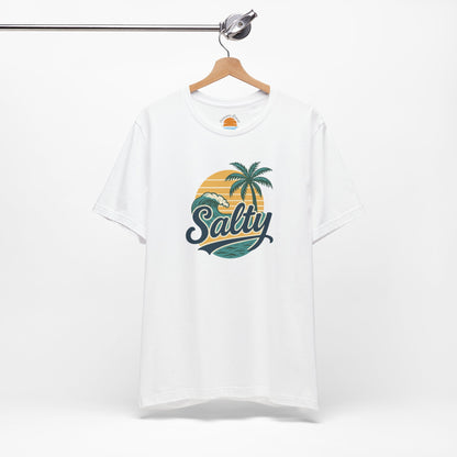 White t-shirt with 'Salty' graphic design featuring palm trees and a sunset on a hanger against a white background.