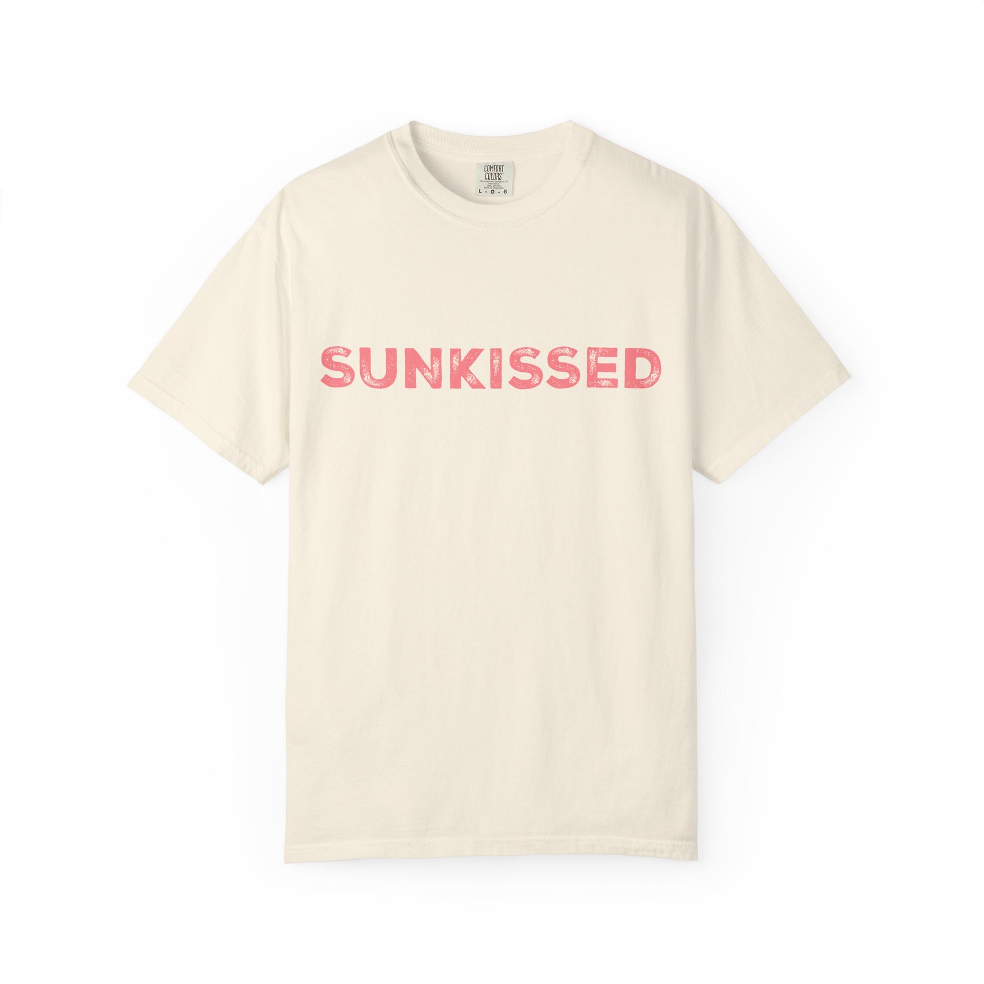 Ivory color Comfort Colors T-shirt with 'Sunkissed'  text in pink on a white background