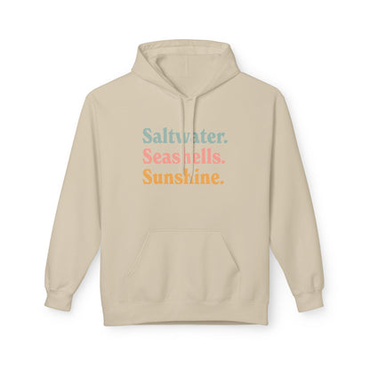 A light beige pullover hoodie with a front kangaroo pocket and drawstring hood, featuring the text 'Saltwater. Seashells. Sunshine'
