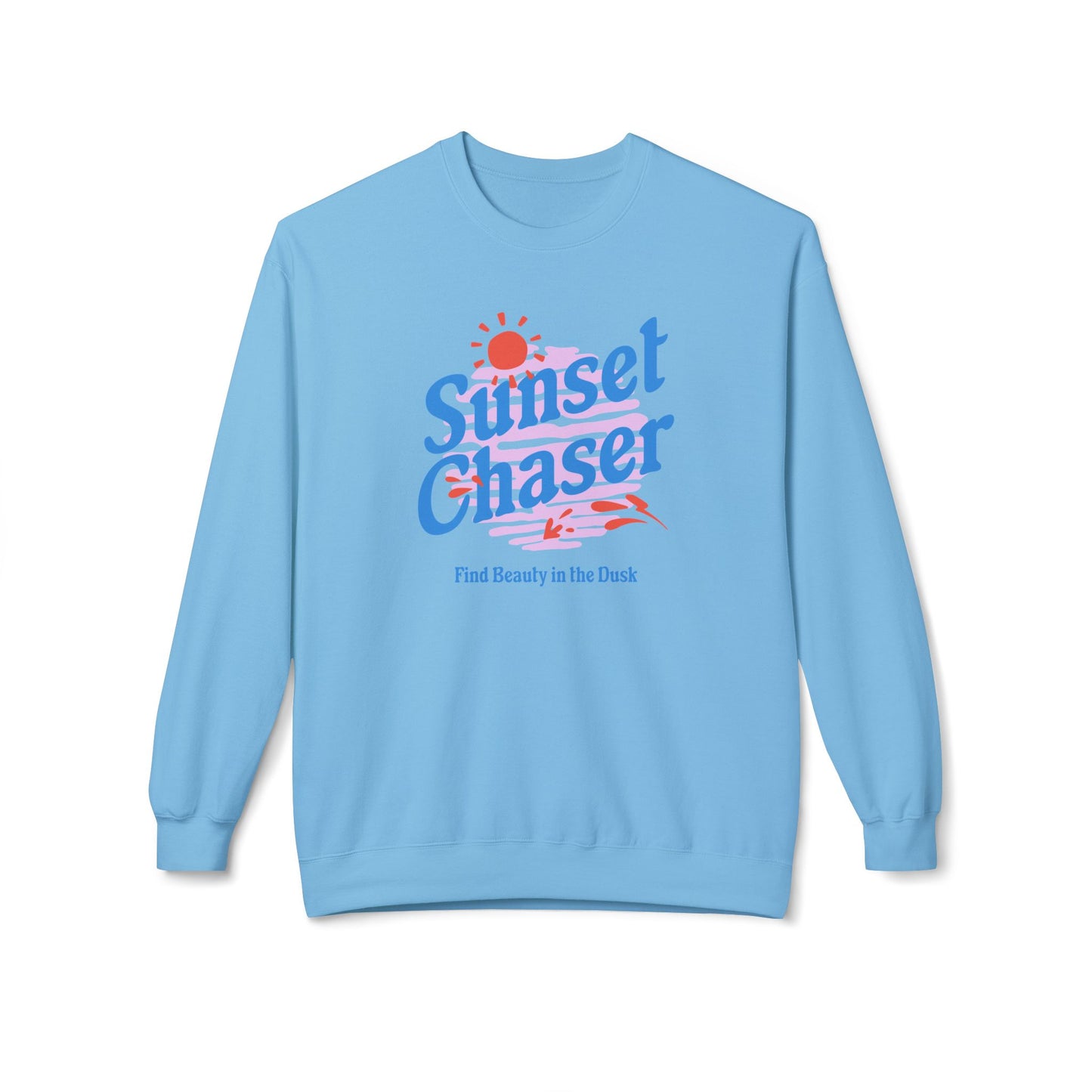 A light blue crewneck sweatshirt featuring a retro-style graphic on the chest with the text 'Sunset Chaser' in blue and red, a small red sun, and the phrase 'Find Beauty in the Dark' underneath, displayed on a clean white background.