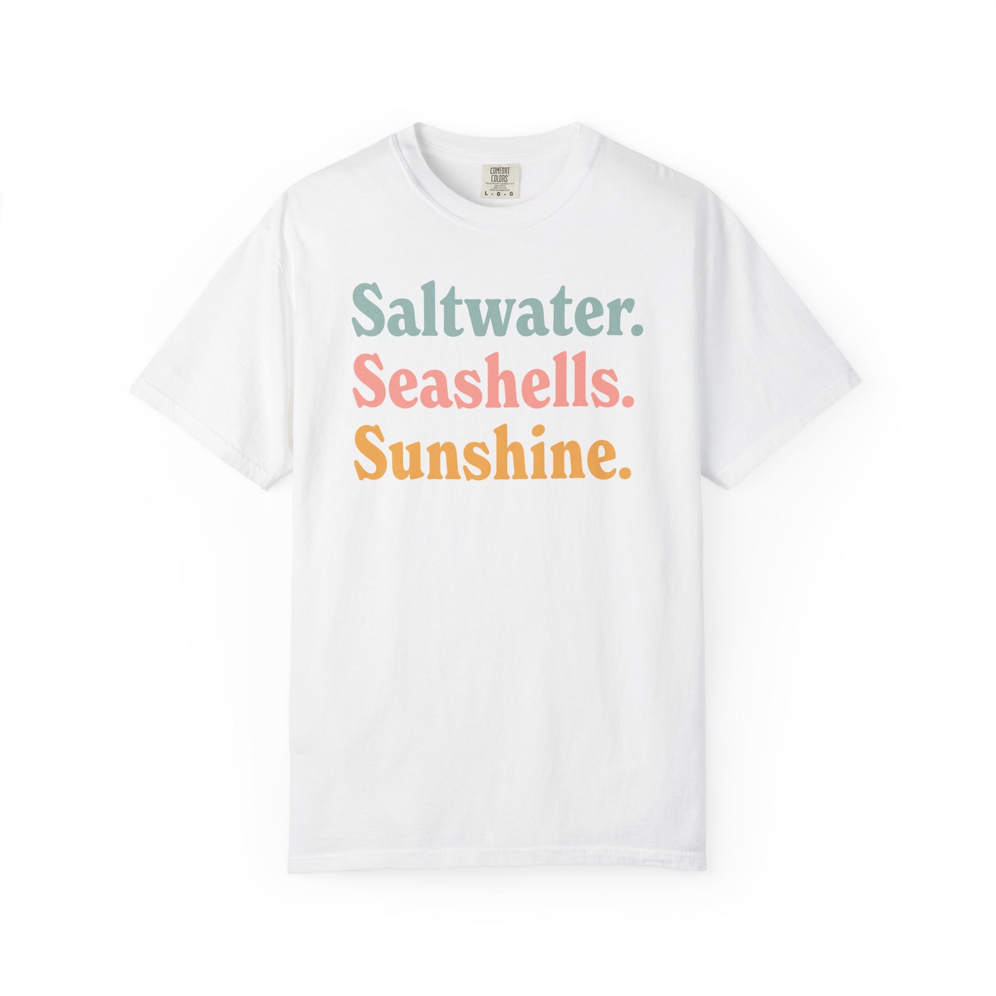 White Comfort Colors t-shirt with colorful text 'Saltwater. Seashells. Sunshine.' on a white background