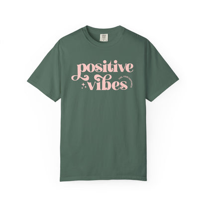 Green t-shirt with pink 'Positive Vibes' text on a white background