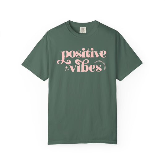 Green t-shirt with pink 'Positive Vibes' text on a white background