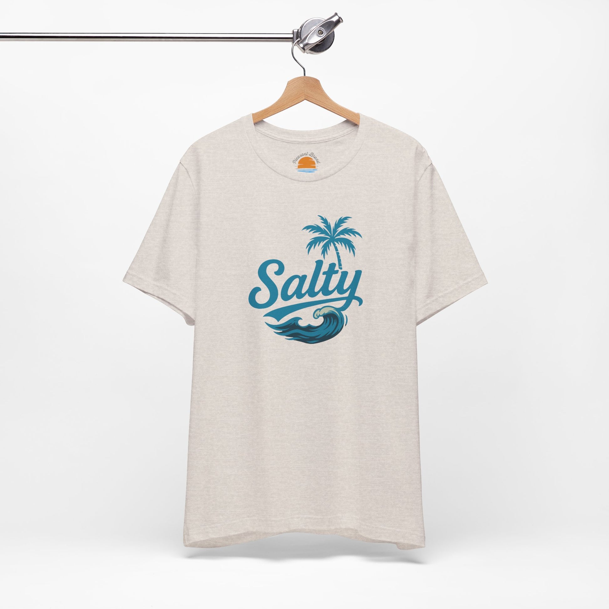 Heather dust t-shirt with 'Salty' blue wave and palm tree design on a hanger against a white background