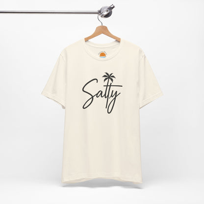 Beige t-shirt with 'Salty' and a palm tree design on a hanger against a white background