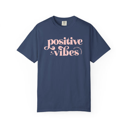 Blue t-shirt with pink 'Positive Vibes' text on a white background