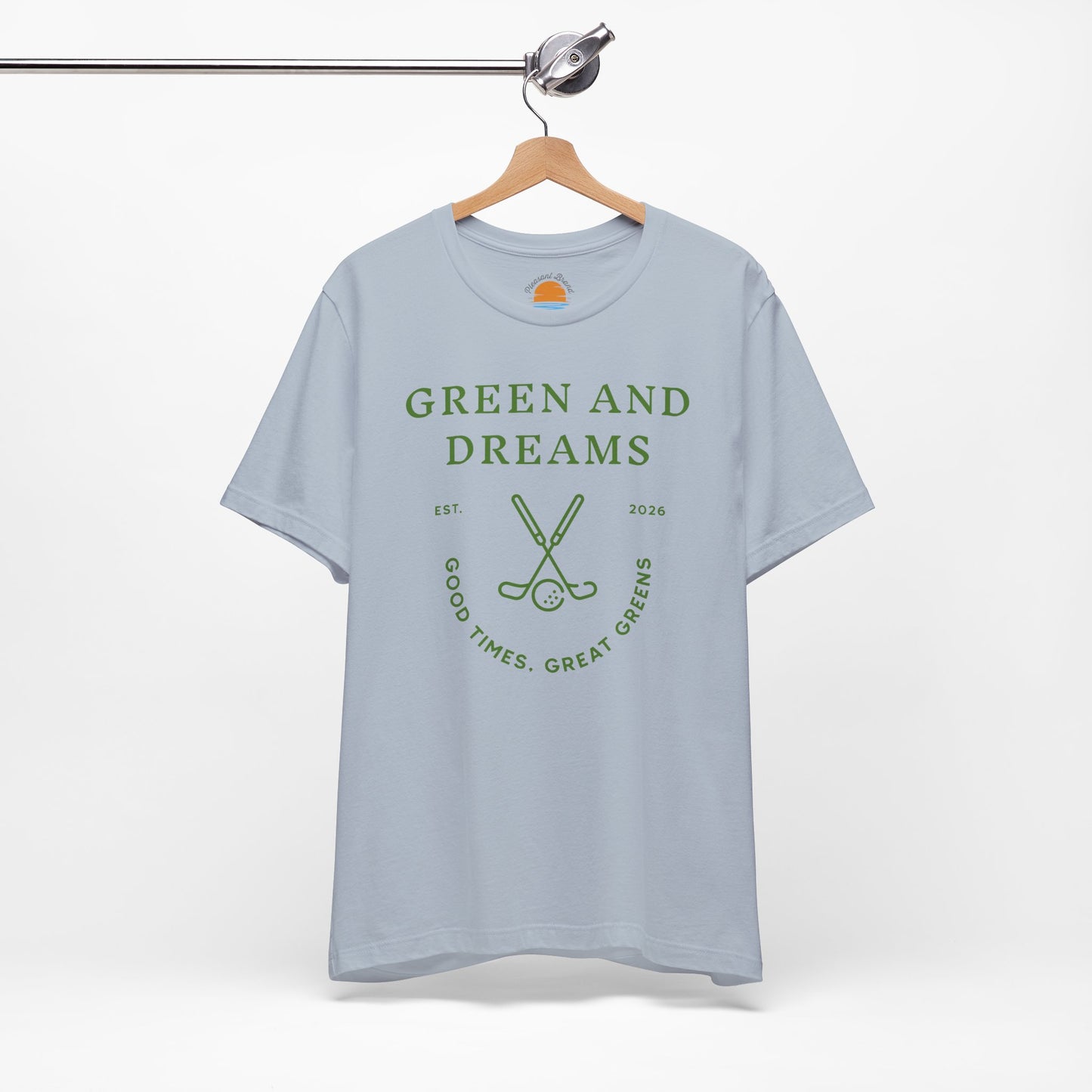 Light blue t-shirt with 'Green and Dreams' graphic design and text on a hanger against a white background