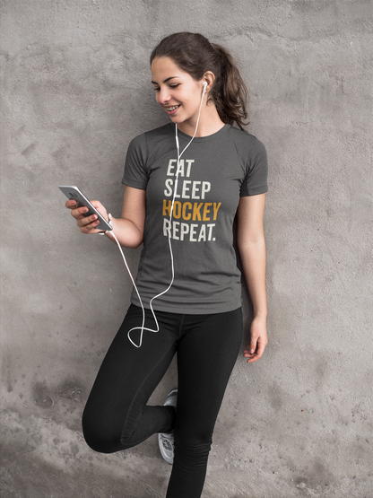 Smiling teen in Eat Sleep Hockey Repeat Youth T-Shirt in relaxed lifestyle pose with phone and earbuds