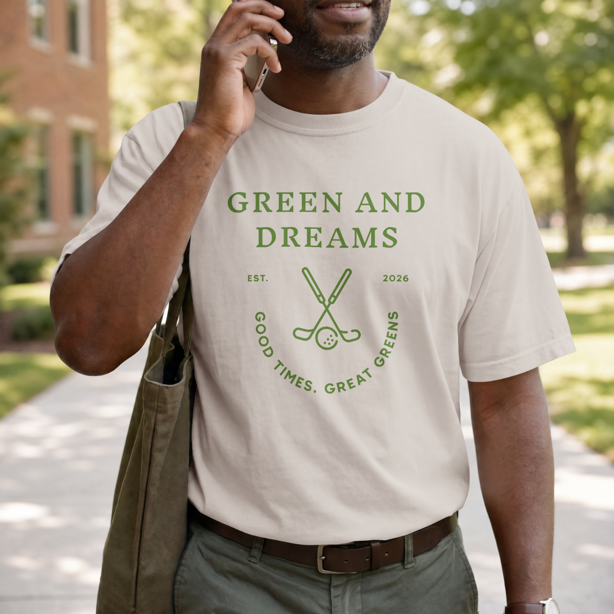 Man wearing a 'Green and Dreams' t-shirt outdoors