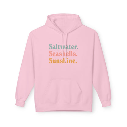 A light pink pullover hoodie with a front kangaroo pocket and a graphic text 'Saltwater. Seashells. Sunshine'