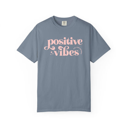Gray t-shirt with pink 'Positive Vibes' text on a white background