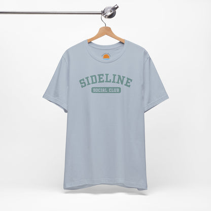 Light blue t-shirt with 'Sideline Social Club' text on a hanger against a white background