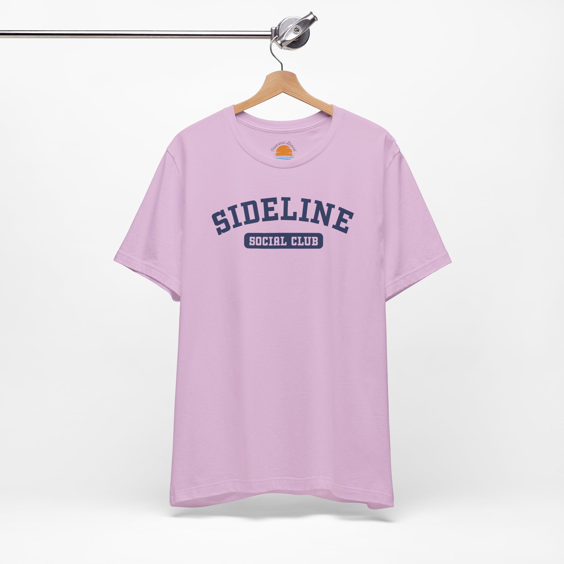 Lilac t-shirt with 'Sideline Social Club' text on a hanger against a white background