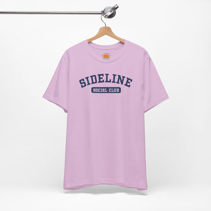 Lilac t-shirt with 'Sideline Social Club' text on a hanger against a white background