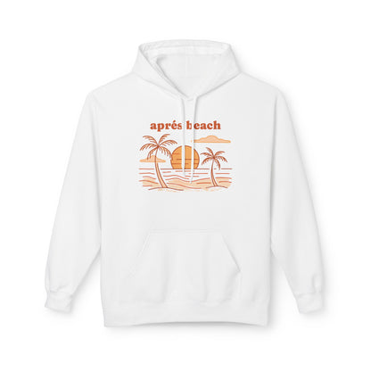 A white pullover hoodie with a retro-style beach graphic on the chest. The graphic features the text 'après beach' in orange above a simple illustration of palm trees, a sunset, and ocean waves.