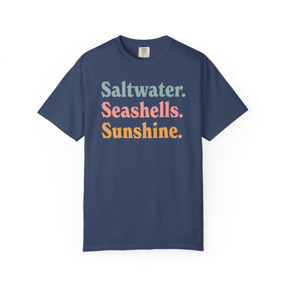 China blue Comfort Colors t-shirt with colorful text 'Saltwater. Seashells. Sunshine.' on a white background