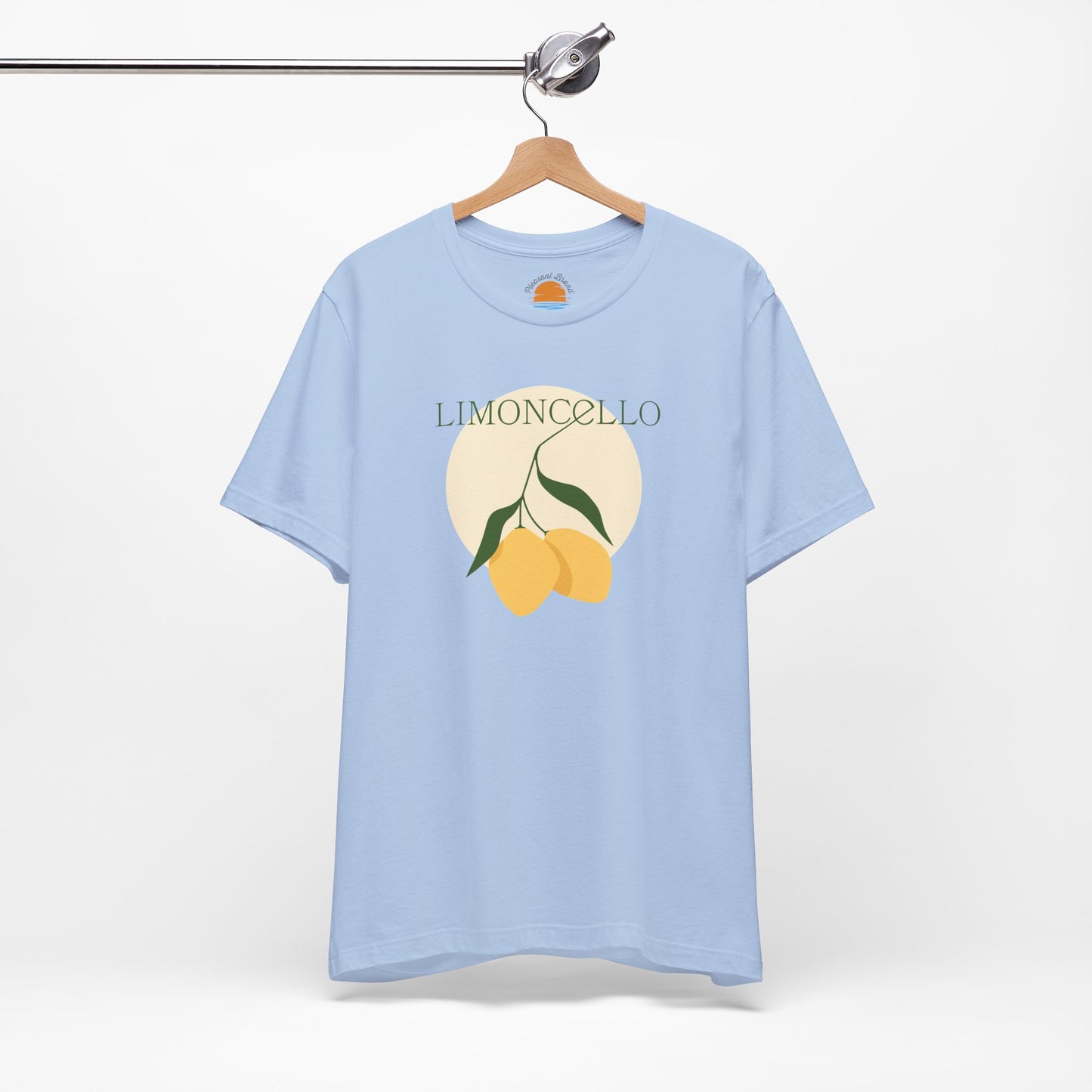 Light blue t-shirt with lemon design and 'Limoncello' text on a hanger against a white background