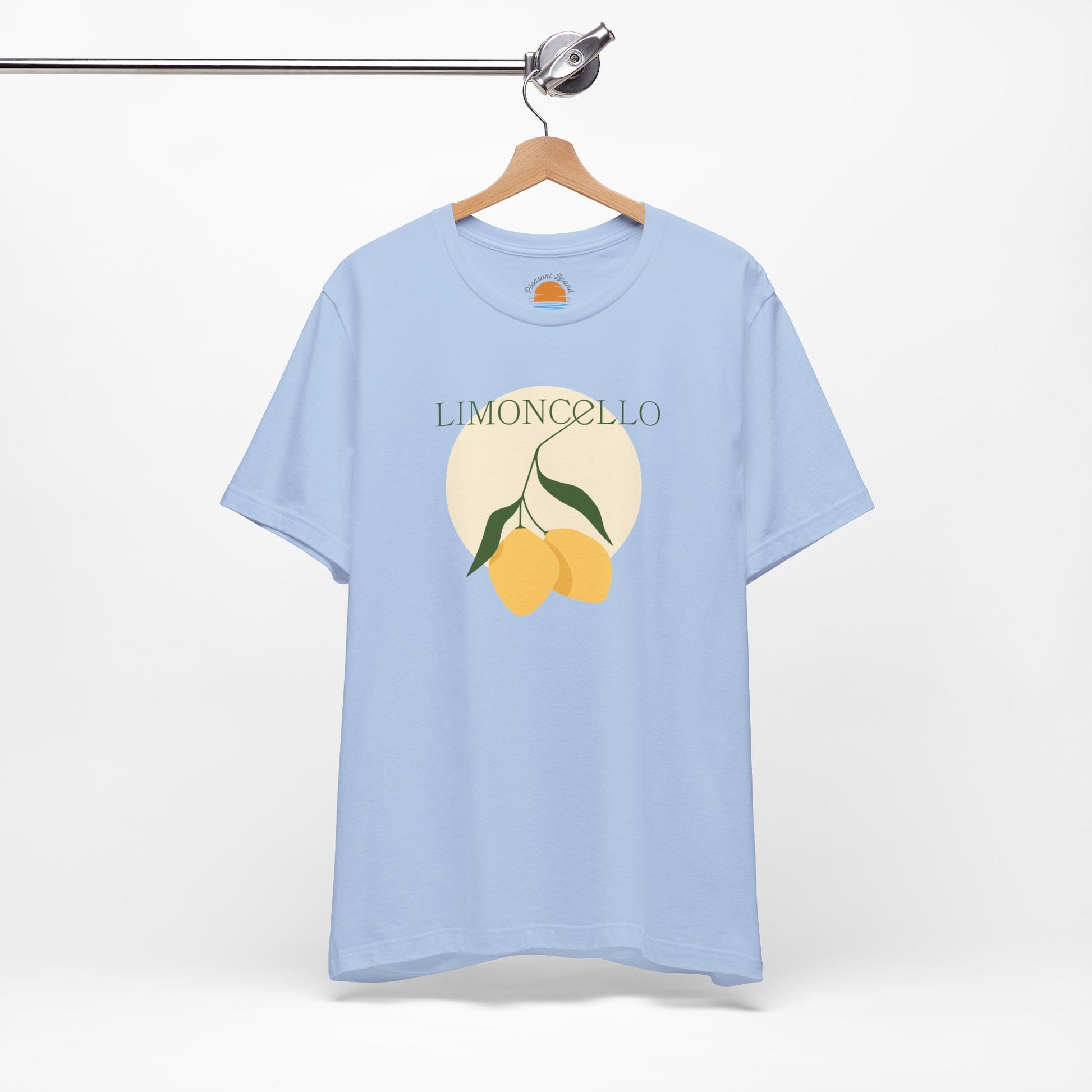 Light blue t-shirt with lemon design and 'Limoncello' text on a hanger against a white background