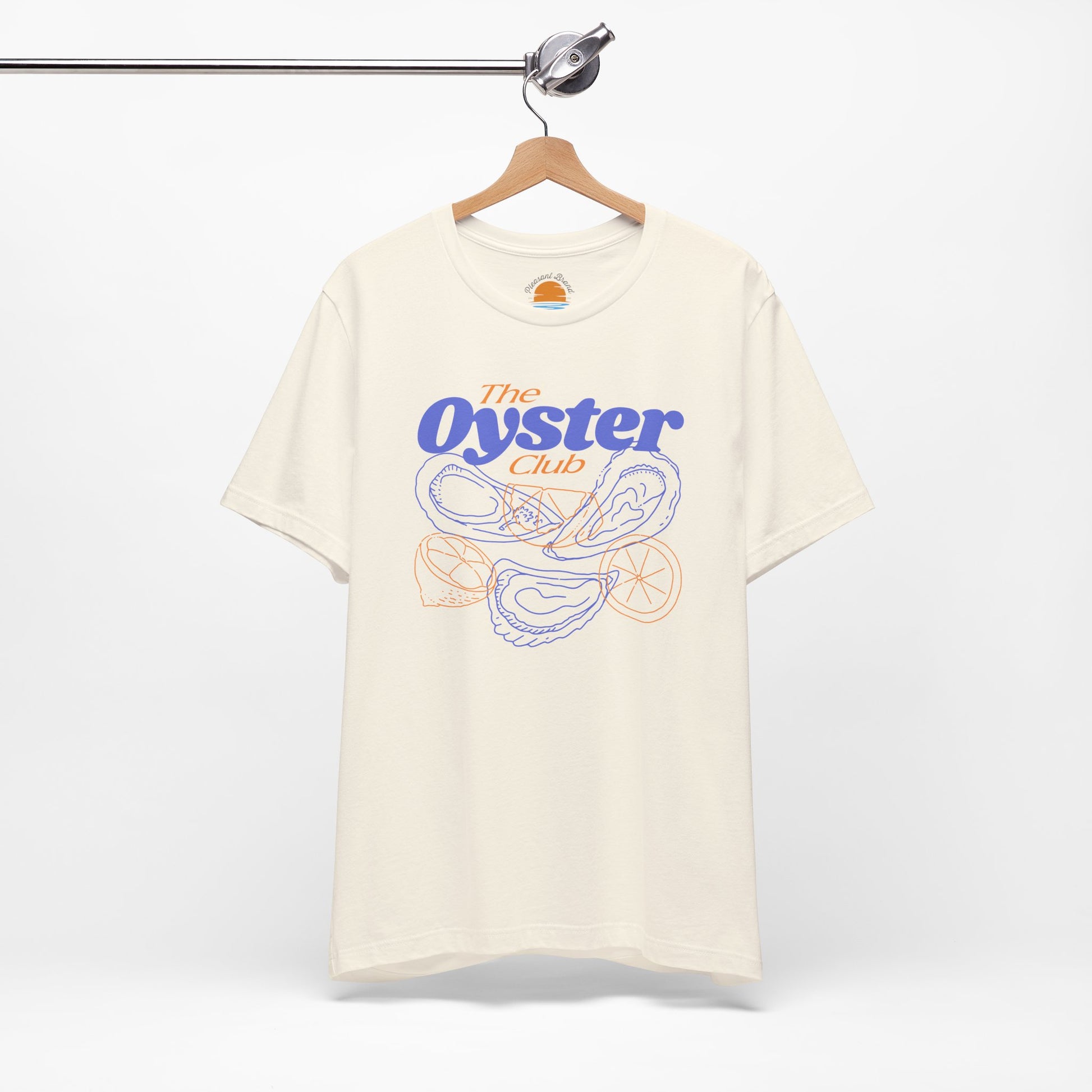Natural color t-shirt with 'The Oyster Club' graphic on a hanger against a white background