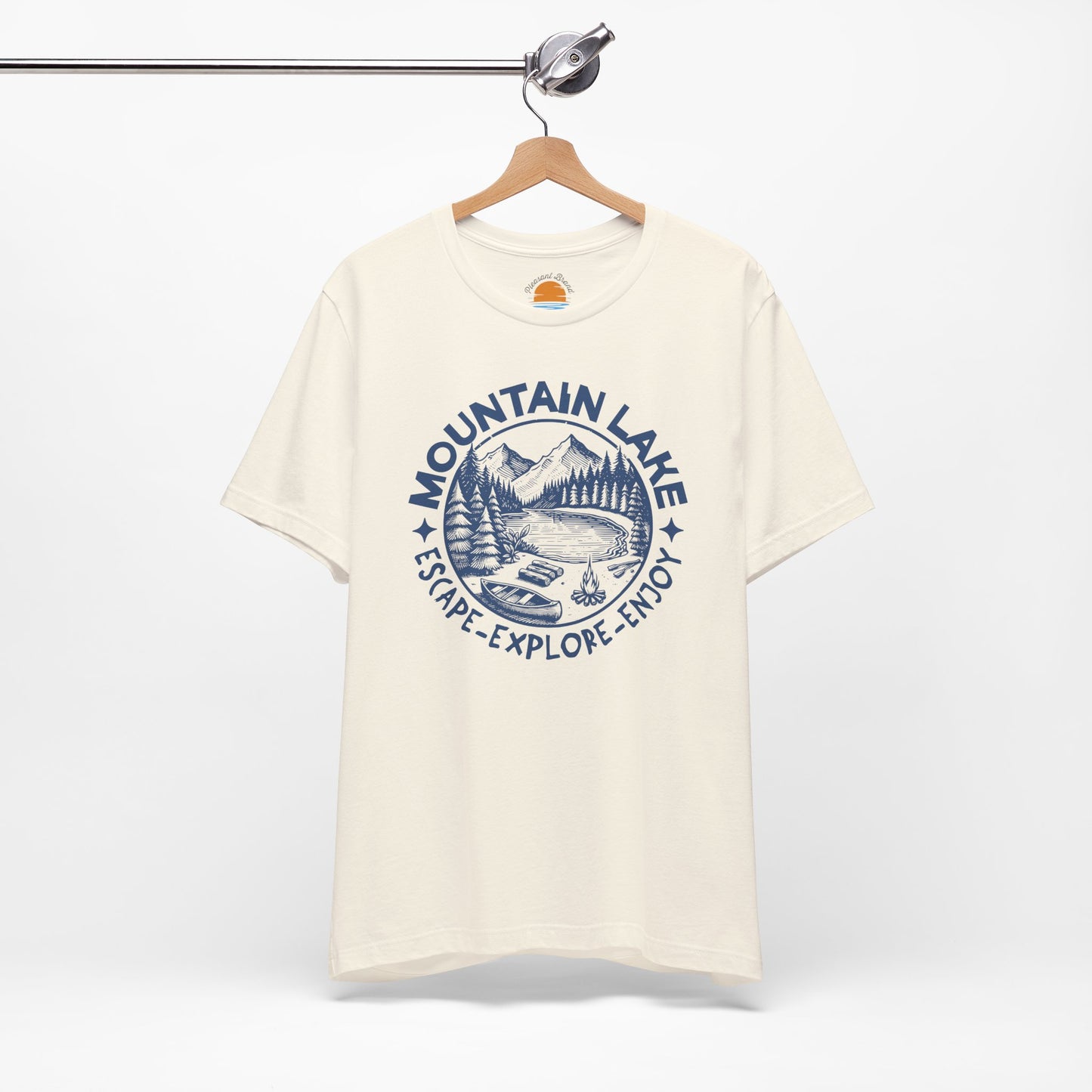 Natural color t-shirt with blue 'Mountain Lake' graphic on a hanger against a white background