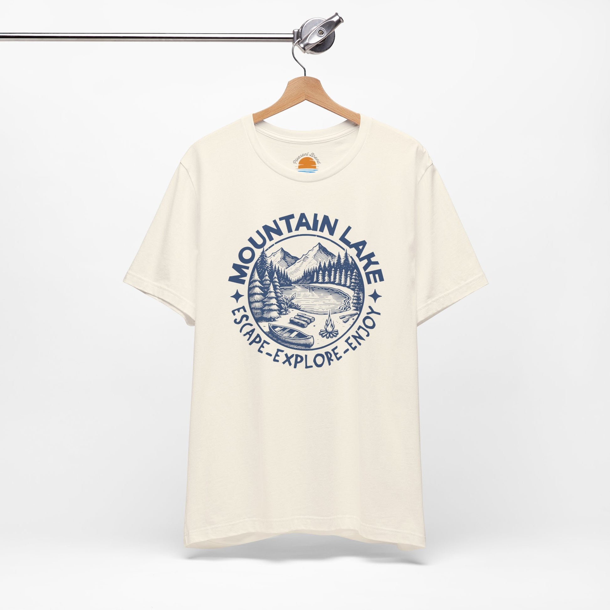 Natural color t-shirt with blue 'Mountain Lake' graphic on a hanger against a white background