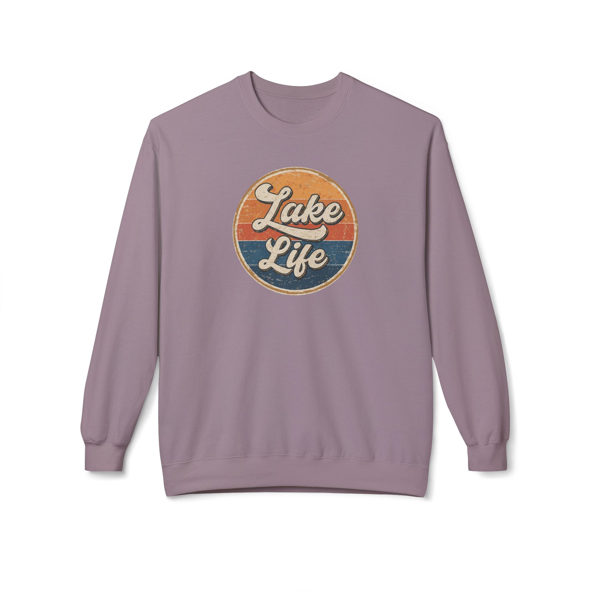 A dusty purple crewneck sweatshirt featuring a retro circular graphic on the chest with the text 'Lake Life' in white script over orange and blue sunset stripes.